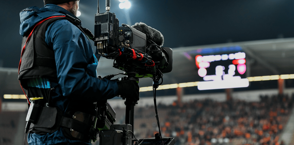 Cameraman behind playing field during football