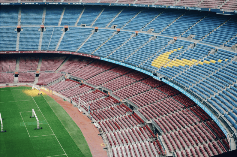 Interior of a stadium filled with rows of empty seats mimicing sports sponsorship value